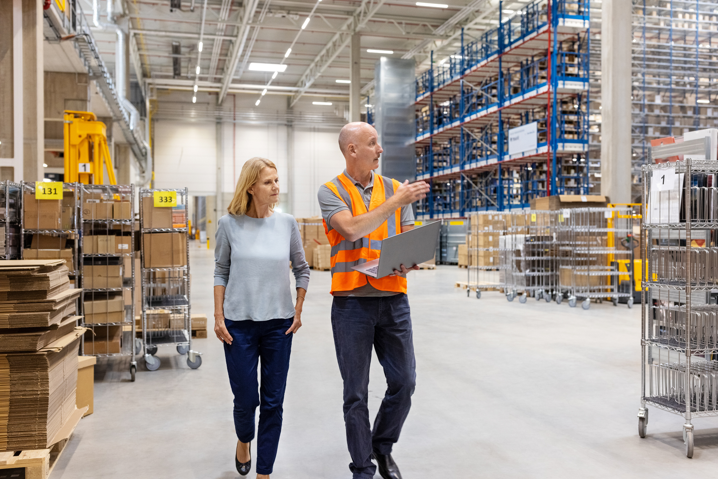 Warehouse foreman discussing inventory with manager